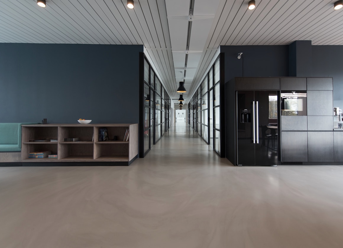 Modern open-plan office workspace with natural light where PR consultants collaborate